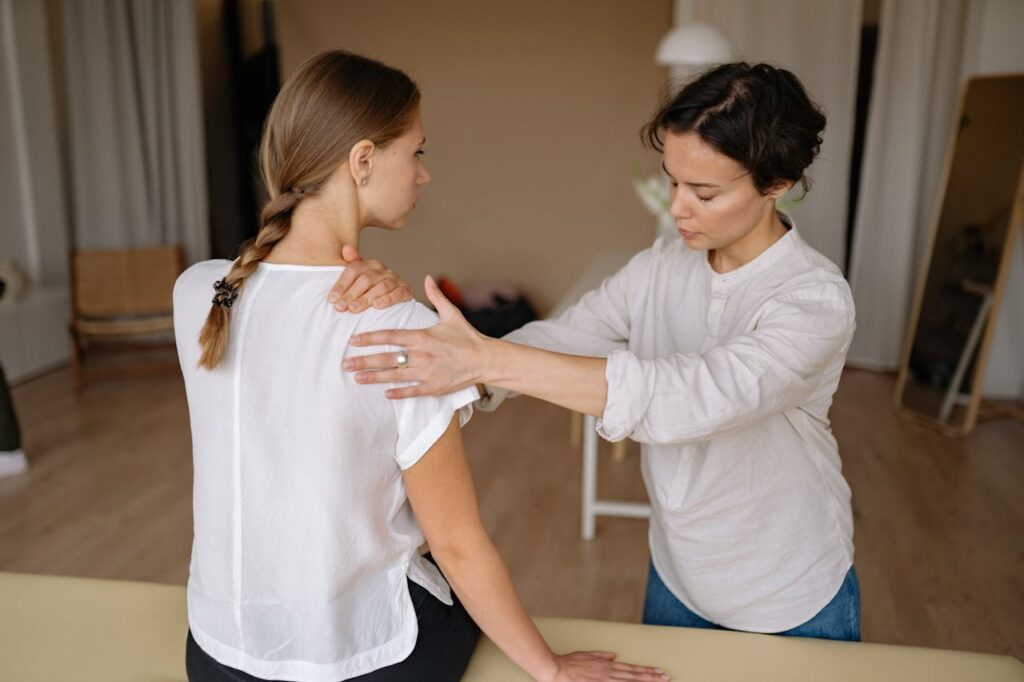 Massage Therapist Massaging Womans Shoulder